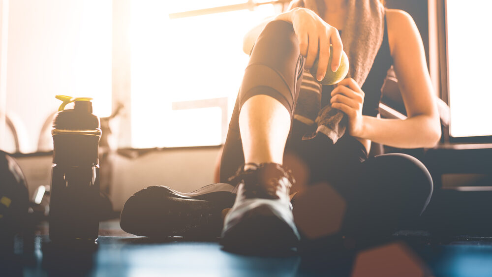 Women sitting on the floor resting between workout